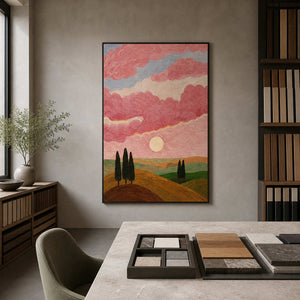 Black framed painting of pink skies and green hills in an architectural materials studio.