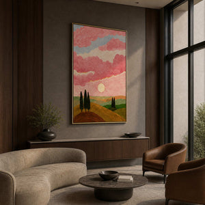 Gold framed pink cloud landscape displayed beside seating in a boutique hotel lobby.