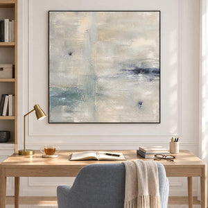 Square neutral abstract painting with ivory, pale aqua, and blue-gray marks in a black frame in a reading room.