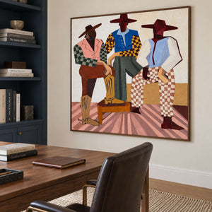Colorful geometric group painting behind a wood desk beside dark blue bookshelves.