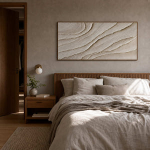 Ivory textured wall art displayed above a warm wood bed.