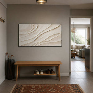 Ivory relief wall art displayed in a restrained home entryway.