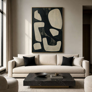 Modern black and ivory abstract wall art in a refined living room.
