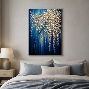 Cascading blue and ivory floral canvas displayed above a modern bed.