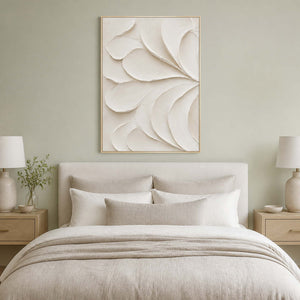 Ivory sculptural wall art displayed in a sage green bedroom.