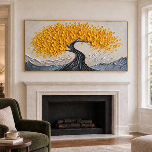 Flowering tree artwork above a white fireplace near a green chair.