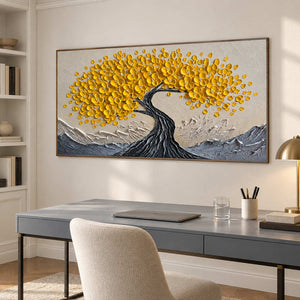 Textured tree artwork above a gray desk and cream chair.