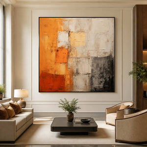 Black framed orange and cream wall art above hotel lounge seating.