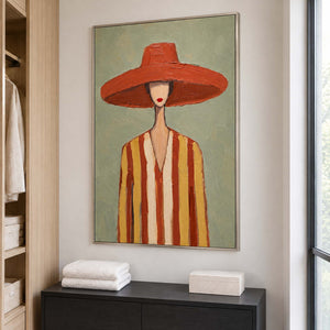 Warm-hat portrait over a dark dresser holding folded white towels and a pale box.