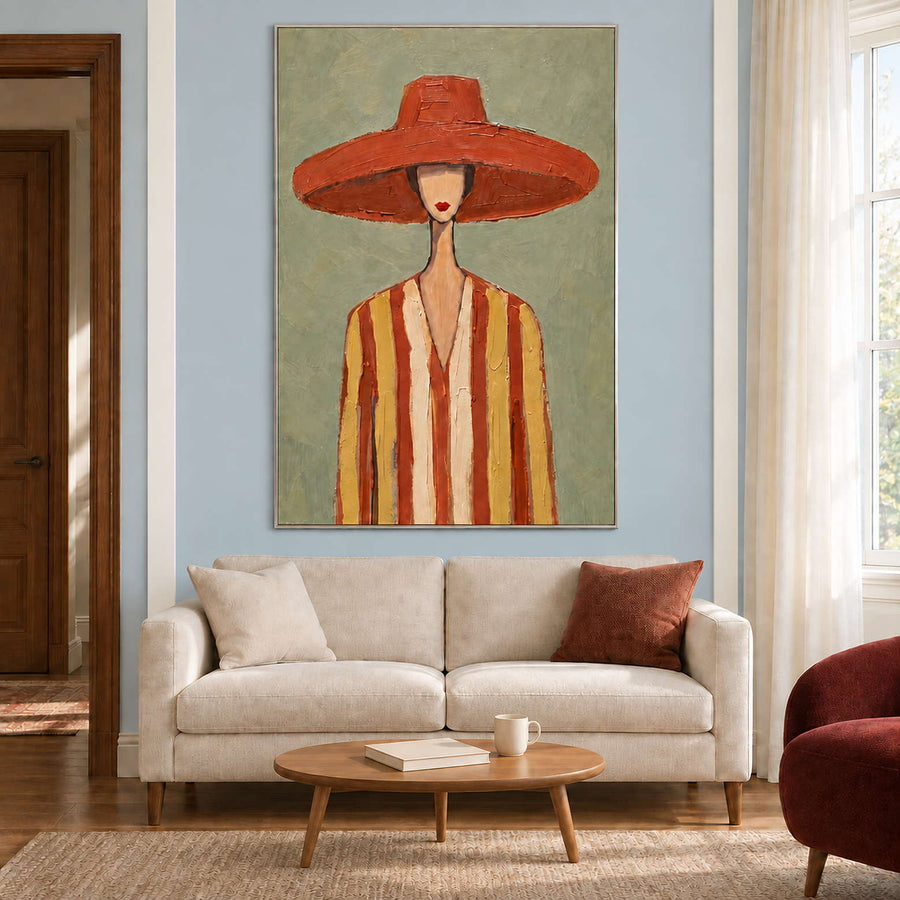 Terracotta-hat portrait above a cream loveseat with a small oval wooden coffee table.
