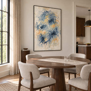 Let Your Thoughts Wander in a black frame beside a round wood dining table and cream upholstered chairs.