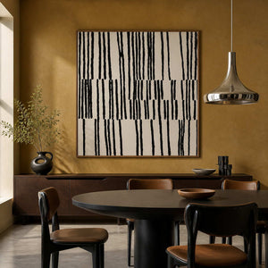 Wood framed black stroke artwork above a sideboard beside a dark dining table.