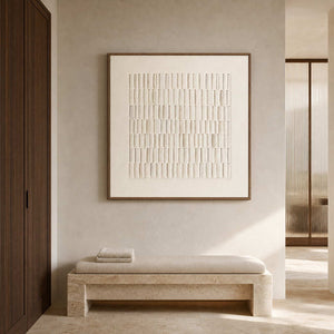 Neutral relief artwork beside a warm stone bench in a spa.
