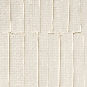 Close-up of raised ivory lines and hand-shaped plaster texture.