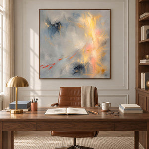 Blue-gray abstract painting with gold, blush, and dark blue marks in a brown wood frame in a home office.