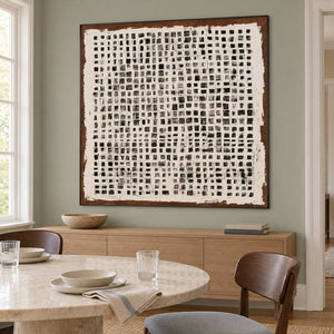 Cream-and-black grid painting on a green dining room wall.