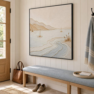Pale coastal painting with sailboats, sandy hills, and curving wave contours in a black frame in an entryway.