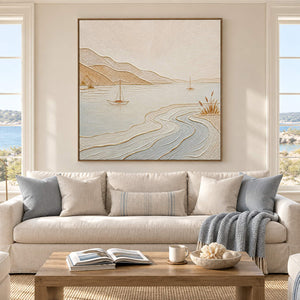 Pale coastal painting with sailboats, sandy hills, and curving wave contours in a brown wood frame in a living room.