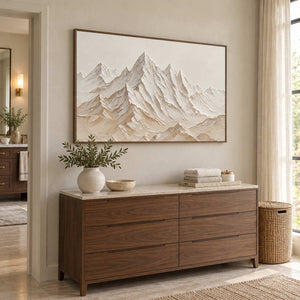 Mountains Keeping Watch in a wood frame above a cabinet with folded towels in a neutral bathroom dry area.