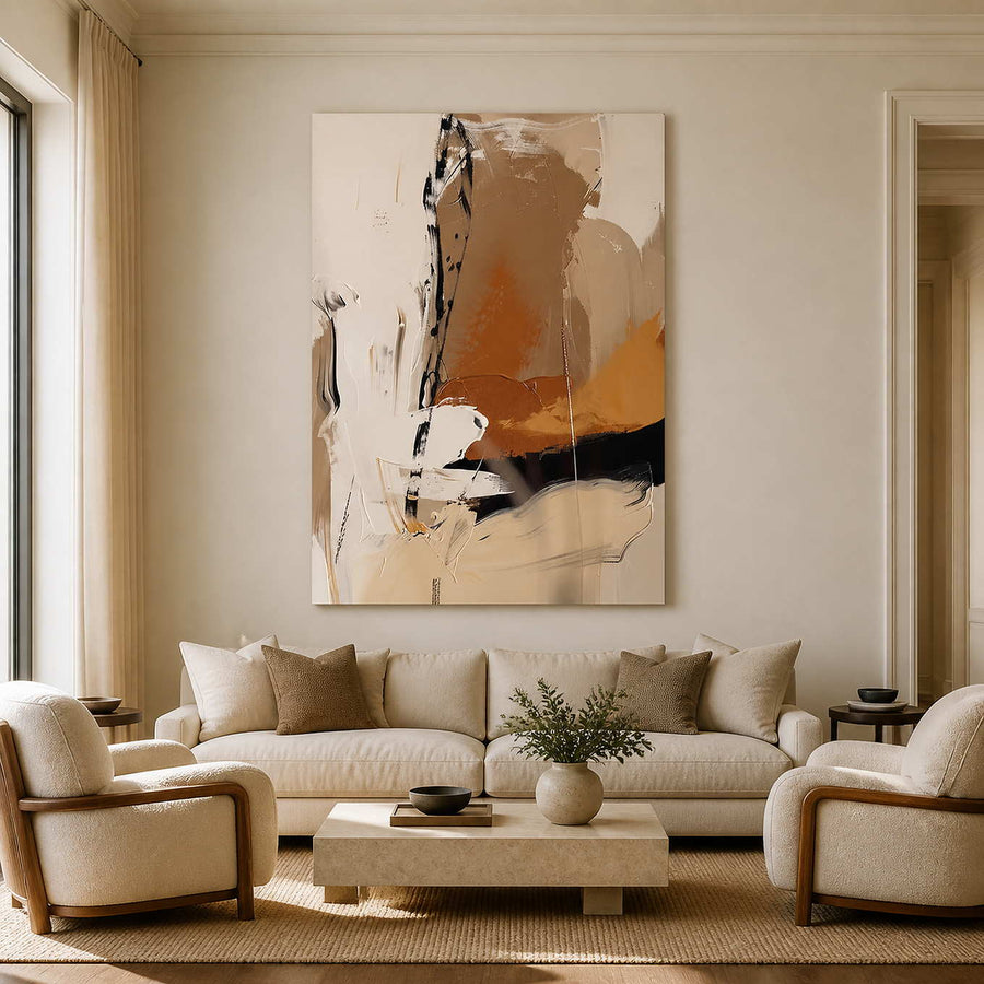 Frameless cream and ochre abstract artwork above a sofa and pale stone coffee table.