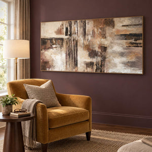 Hand-painted abstract wall art in ivory, taupe, umber, and charcoal, displayed in a reading room in a brown wood frame.