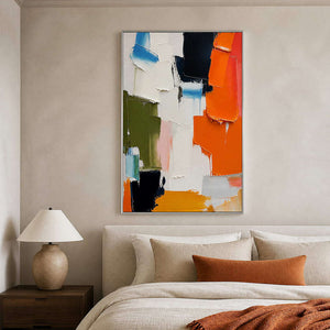 Vivid textured abstract canvas adding warmth above an ivory bed.