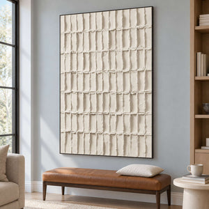 Black-framed ivory grid above a brown bench beside bookshelves.