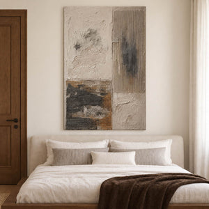Weathered ivory and beige textures with gray blocks and dark marks without an outer frame, displayed above a bed.