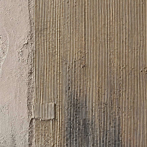 Detail of Peace after Many Years, showing the rough ivory surface and muted gray layers.