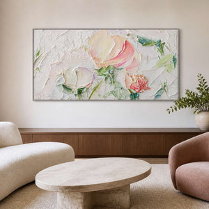 Silver framed pink floral artwork over a walnut sideboard beside rounded lounge seating.