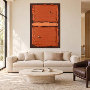 Orange tennis artwork above a cream sofa with a low round coffee table.