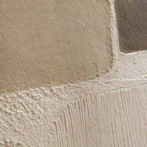 Close-up of raised hand-painted texture in neutral, white, and earth tones.