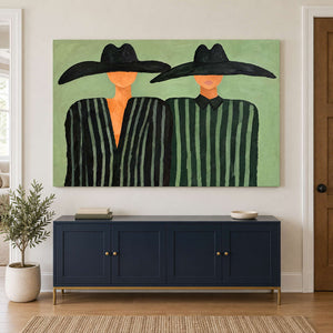 Green-striped pair over a navy sideboard and potted tree.
