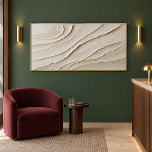 Panoramic ivory abstract wall art with layered flowing relief, displayed in a lounge in a gold frame.