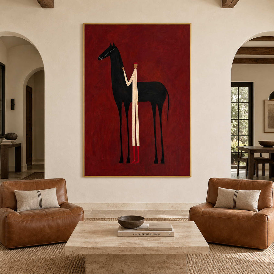 Red-background horse and figure artwork above two tan leather chairs and a pale coffee table.