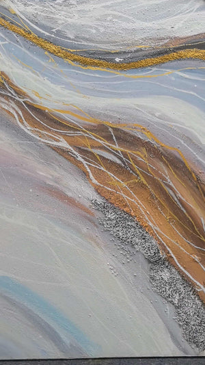 Photographed view of pale blue-gray bands curving around ochre areas with fine white lines, with the artwork edge and surrounding background visible.