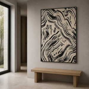 Black framed abstract artwork with intersecting bands above a wooden hallway bench.