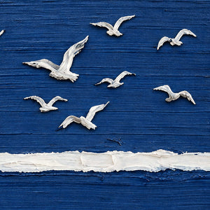 Close-up of Room to Fly showing raised white birds with differently angled wings above a white band on textured deep blue.