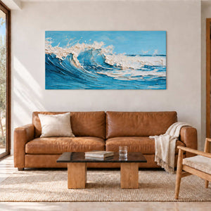 Blue wave painting above a brown sofa with a dark rectangular coffee table.