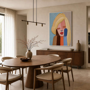 Textured female portrait displayed above a warm wood dining room.