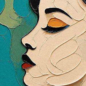Close-up of raised ivory facial contours with black, teal, and orange paint.