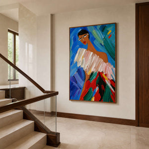 Vertical colorful artwork viewed in a warm stone walnut stair hall.