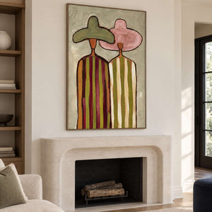 Striped figures artwork above a rounded pale fireplace.