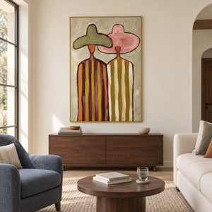 Two-figure portrait above a wooden cabinet between blue and cream seating.