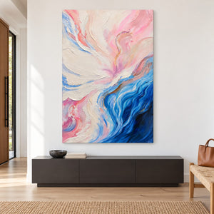 Artwork showing cream and pink folds flowing into deep blue curves at the lower right in an entryway above a console or bench, with no outer frame.