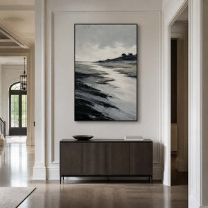 Textured tidal landscape wall art in an elegant entryway with a black frame.