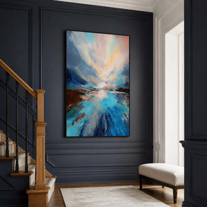 Black framed blue landscape beside wooden stairs against deep blue paneled walls.