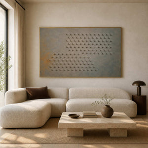 Textured geometric wall art displayed in a warm minimalist living room.