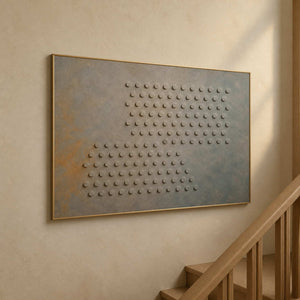 Raised circle artwork displayed beside a softly lit wood stairway.