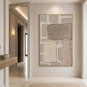 Textured neutral canvas in a gold frame styled in an entryway.